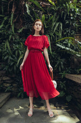 Pleated silk midi dress with soft sheer overlay and gathered waistline for elegant movement